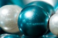 Blue and white beads on a red string. Colorful background. Macro.