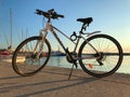 Blue and white bicycle of the HEAD company parked near the sea. Sarafovo fishing port near Burgas, Bulgaria at sunset.