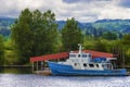 Blue and white boat sits docked along the Willamette River in Or Royalty Free Stock Photo