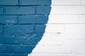 Blue and white brick wall texture background. Street art detail on house exterior. Brush strokes. Old, painted, weathered bricks Royalty Free Stock Photo