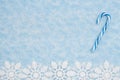 Blue and white candy cane with white snowflakes background Royalty Free Stock Photo