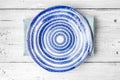 Blue and white ceramic plate on the white wooden table Royalty Free Stock Photo