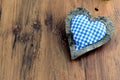 Blue white checkered heart pillow on wooden background with copy Royalty Free Stock Photo