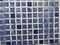 Blue and white color checked ceramic designed tiles for wall finishes for an Toilet work with abstract background