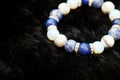 Blue and white color tone lucky fortune stone bracelet include which Lapis lazuli, Sodalite, Howlite and Moonstone on black wool b