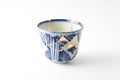 Blue and white decorated cup repaired with the antique kintsugi real gold technique Royalty Free Stock Photo