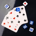 Blue and white dices and cards on black glossy background. flat lay Royalty Free Stock Photo