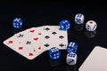 Blue and white dices and cards on black glossy background Royalty Free Stock Photo