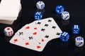 Blue and white dices and cards on black glossy background Royalty Free Stock Photo