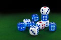 Blue and white dices on the green velvet surface Royalty Free Stock Photo