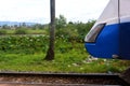 Blue and white diesel locomotive next to the lotus