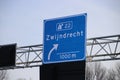 Blue and white direction sign of junction 22 Zwijndrecht on motorway A16 in the Netherlands. Royalty Free Stock Photo