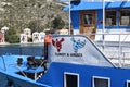 A blue and white Greek boat with the dove`sin blue and white and red and white symbolizing peace between the two countries