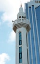 Blue and white Islamic Minaret and Modern Skyscraper