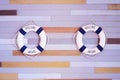 Blue and white Lifeguard ring hanging on wooden wall