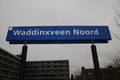 Blue and white namesign at R-NET station Waddinxveen-Noord.