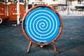 Blue and white optical spiral illusion or swirl effect on a metal board in a playground