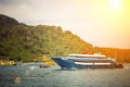 Blue and white passenger ship sailing to destination point. Dock with another ships and mountain on background Royalty Free Stock Photo