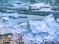 Blue and white pieces of broken ice. Melting of broken ice pieces, crushed floes