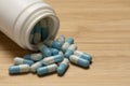 Blue and white Pills Spilling from the Bottle. Royalty Free Stock Photo