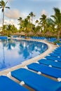 Blue and white plastic lounges around pool Royalty Free Stock Photo