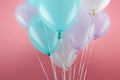 Blue, white and purple decorative balloons on pink background. Royalty Free Stock Photo