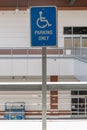 A blue and white reserved parking sign mounted on a metal pole Royalty Free Stock Photo