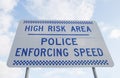 Blue and white road safety sign against a blue cloudy sky