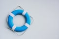 Blue and white safety torus or lifebuoy hanging on white wall background, copy space