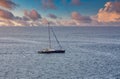 Blue and White Sailboat Alone at Dusk Royalty Free Stock Photo