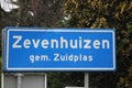 Blue and white sign to mark the start of the urban area in Zevenhuizen in the Netherlands.