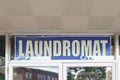 Laundromat sign in a transom window