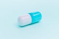 Blue and white single capsule medication