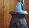 Blue And White Speckled Coffee Pot On Potbellied Stove