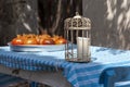 Authentic candle lantern and pommegranades in metal tray on blue and white stiped cotton table cloth at Tenedos Bozcaada Islandd Royalty Free Stock Photo