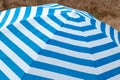 Blue and white striped beach umbrella on the beach Royalty Free Stock Photo