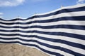 Blue and white striped windbreak at the beach Royalty Free Stock Photo