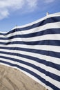 Blue and white striped windbreak at the beach Royalty Free Stock Photo