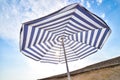 Blue and white sun beach umbrella and blue sky with clouds Royalty Free Stock Photo