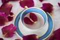 Blue and white tea cup with rose petals