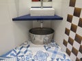 Blue and white tiled floor and zinc tub