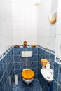 Blue white tiled toilet room with sink