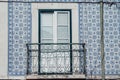 Blue and white tiled window with iron balcony in Lisbon Portugal Royalty Free Stock Photo