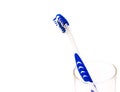 A blue white tooth brush in glass