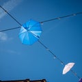 A blue and white umbrellas against the blue sky Royalty Free Stock Photo