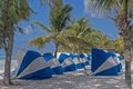 Blue and white umbrellas are placed in a row ready for tourists. Royalty Free Stock Photo