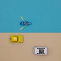 A blue and white van and a yellow beetle pass in front of the river and a blue boat with oars. Minimal life concept