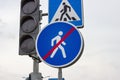 Blue and white warning pedestrian walkway sign with red forbid line indicating the end of the area, large round roadside traffic