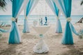 Blue and white wedding aisle in a beach surrounded by palms with the sea on the background Royalty Free Stock Photo