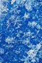 Blue white winter background from snowflakes blur